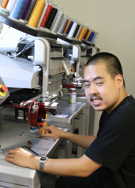 Haronie working at the embroidery station
